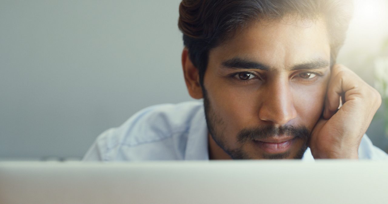 A man looking at his laptop