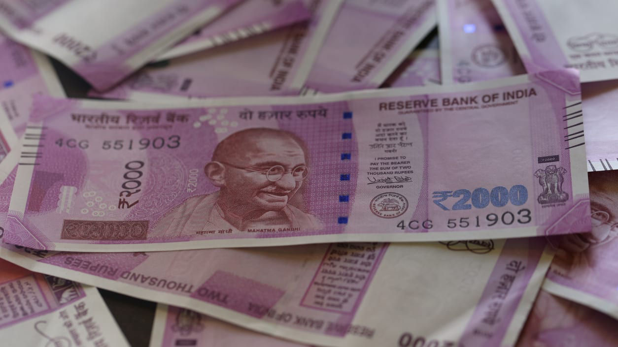 A pile of indian currency notes on a table.