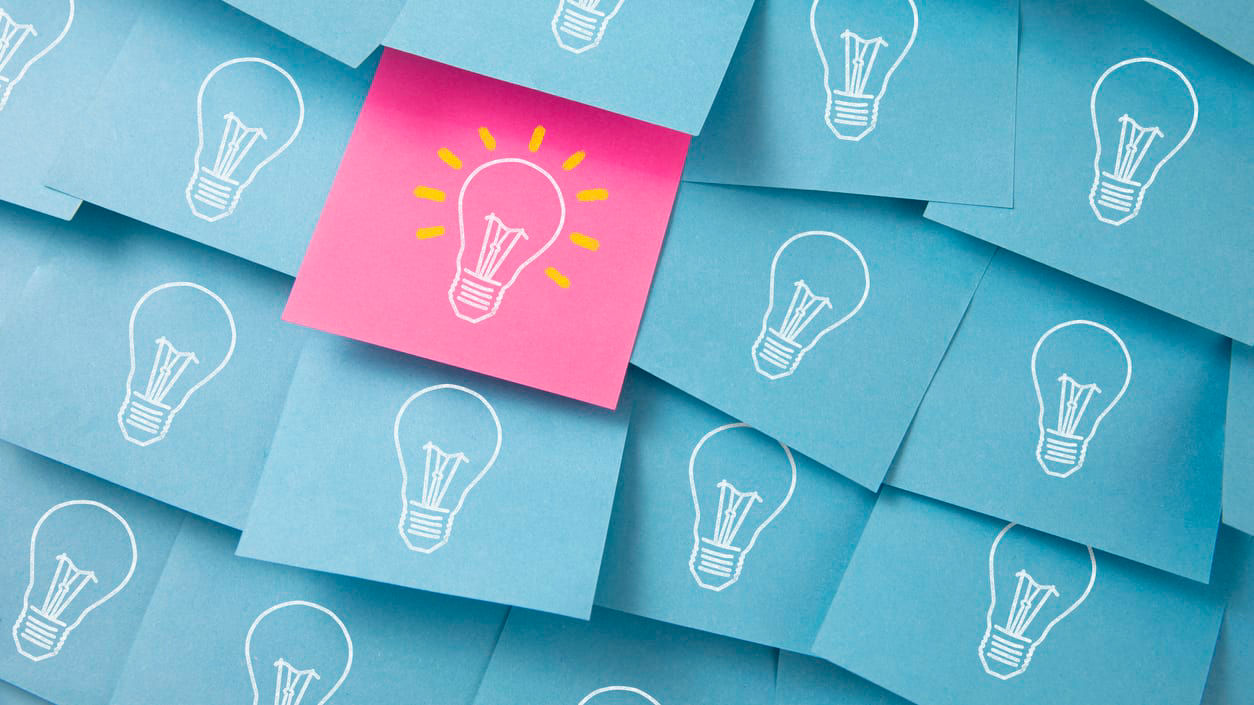 A bunch of sticky notes with light bulbs on them.