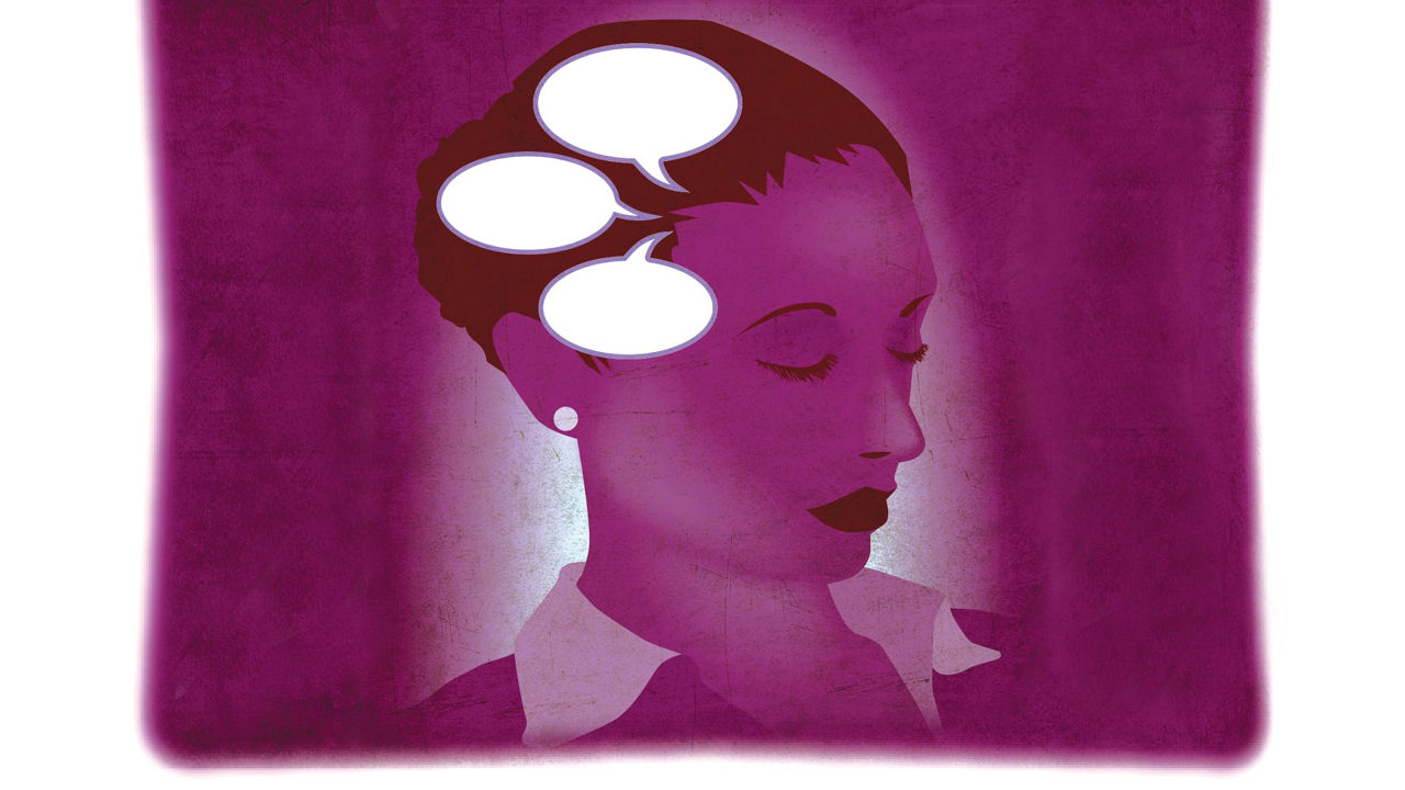 A purple pillow with a woman's head and speech bubbles.