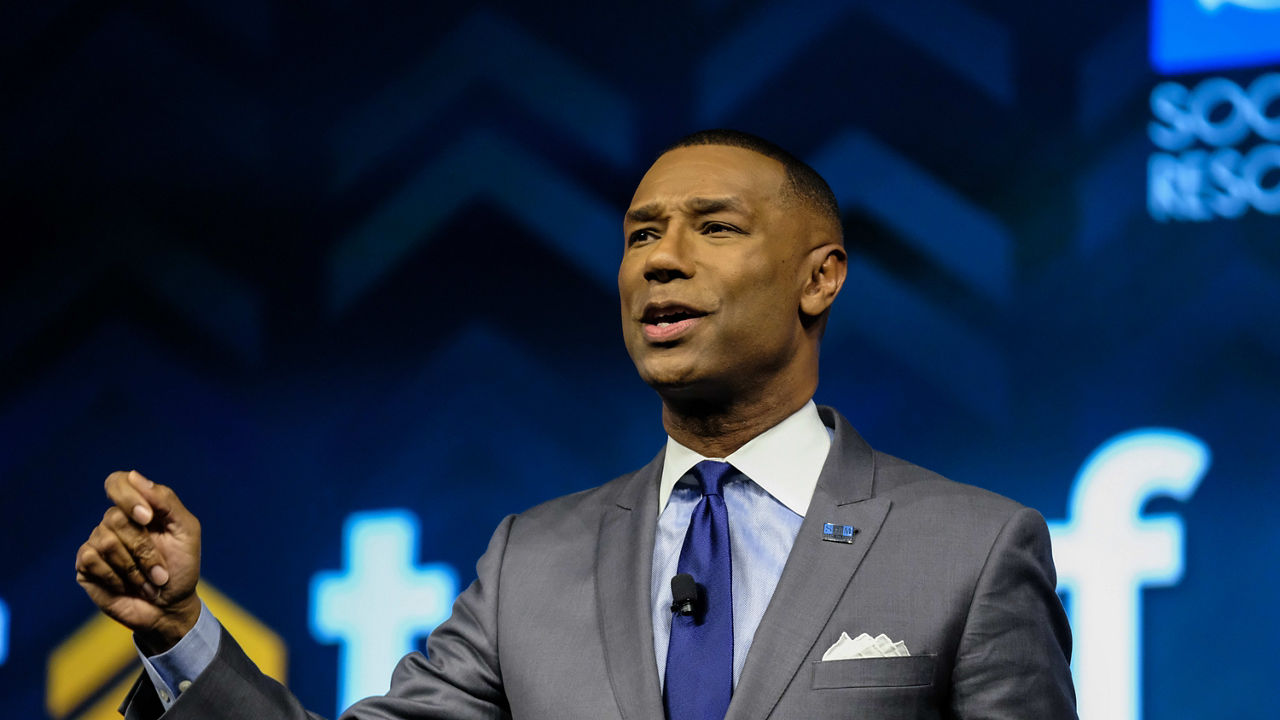 Johnny C. Taylor Jr. giving a speech at a conference.