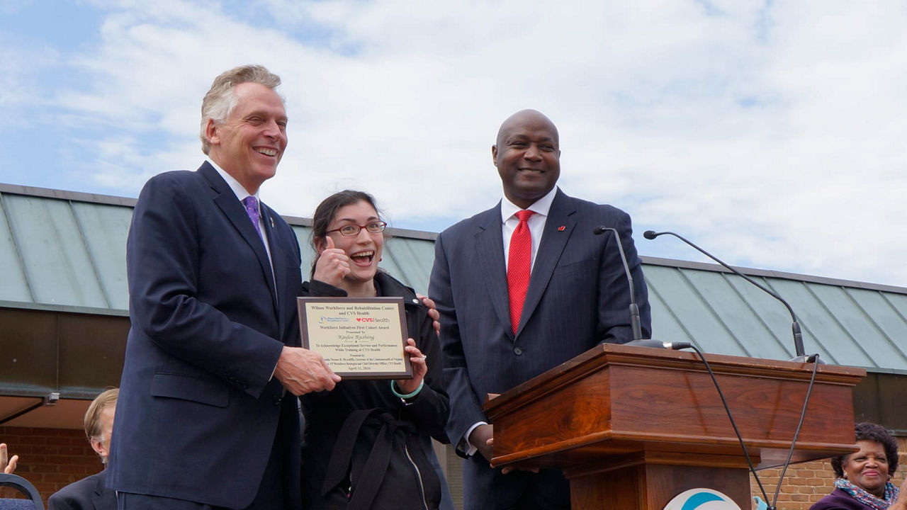 A man holding a plaque.