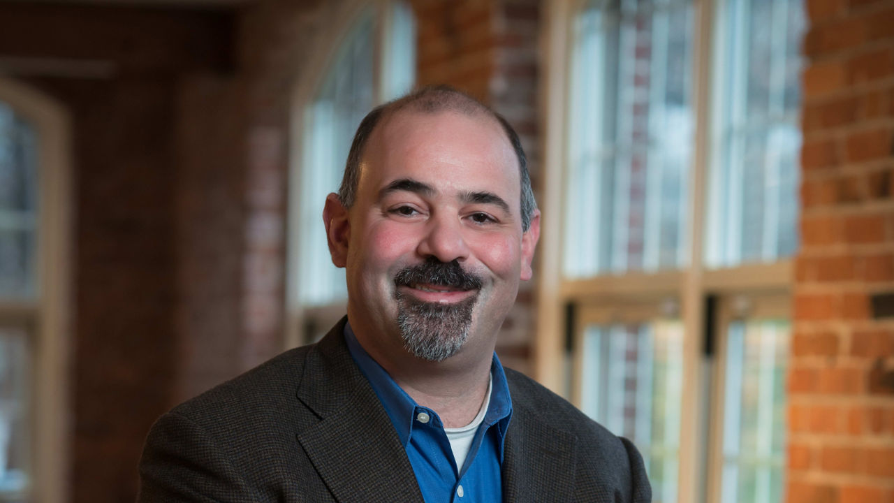 A man sitting on a chair in a room.