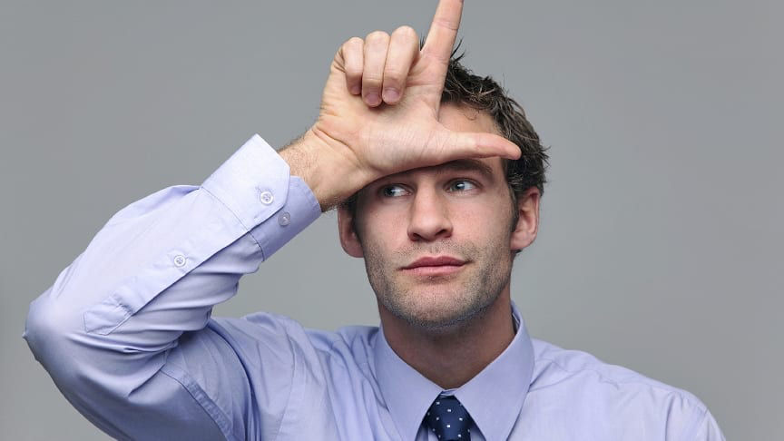 A businessman making a hand gesture with his finger.