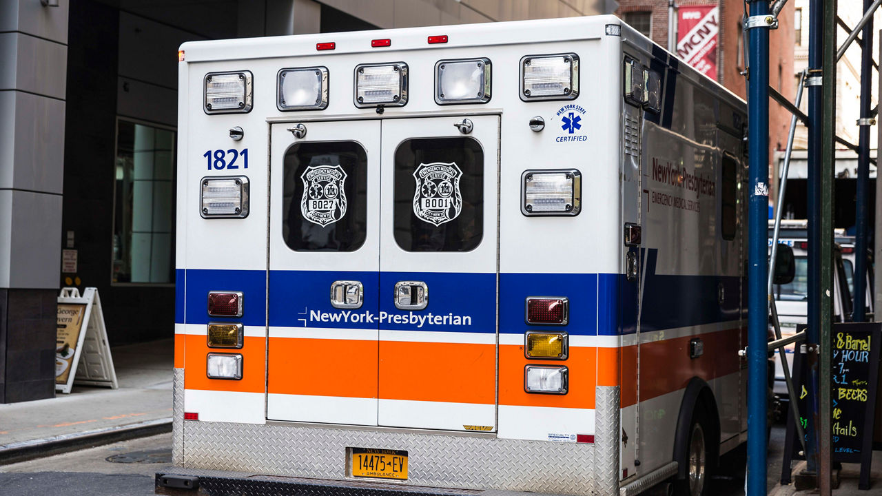 An ambulance parked on the side of a street.