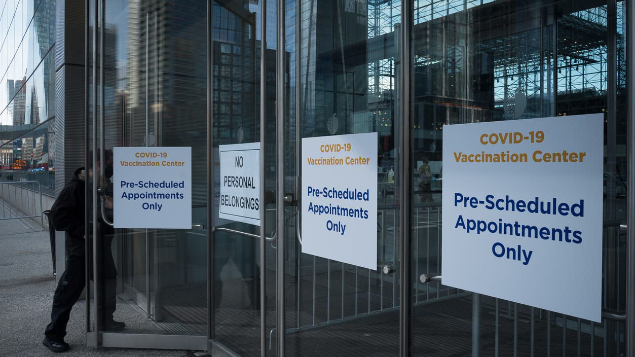 A man walks through the doors of a covid-19 center.