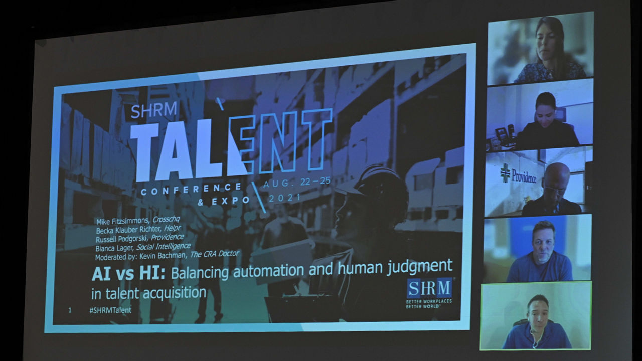 A screen showing a group of people in a room.