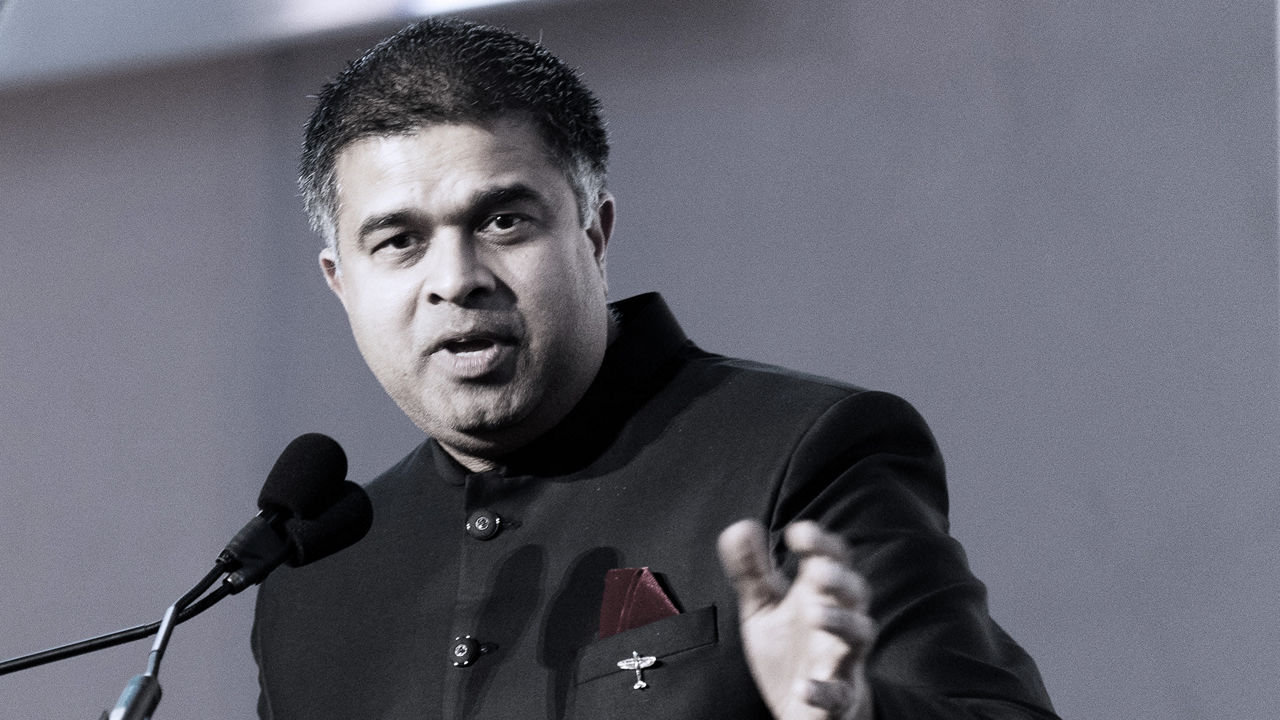 A man giving a speech into a microphone.