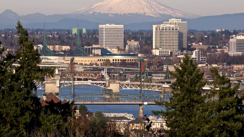 A view of the portland skyline with mt hood in the background.