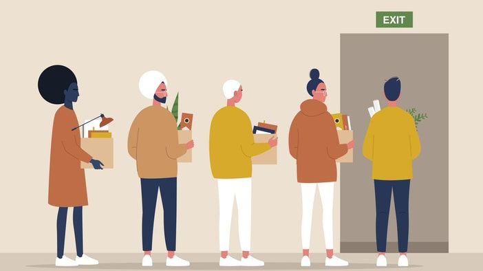 A group of people standing in front of an exit door.