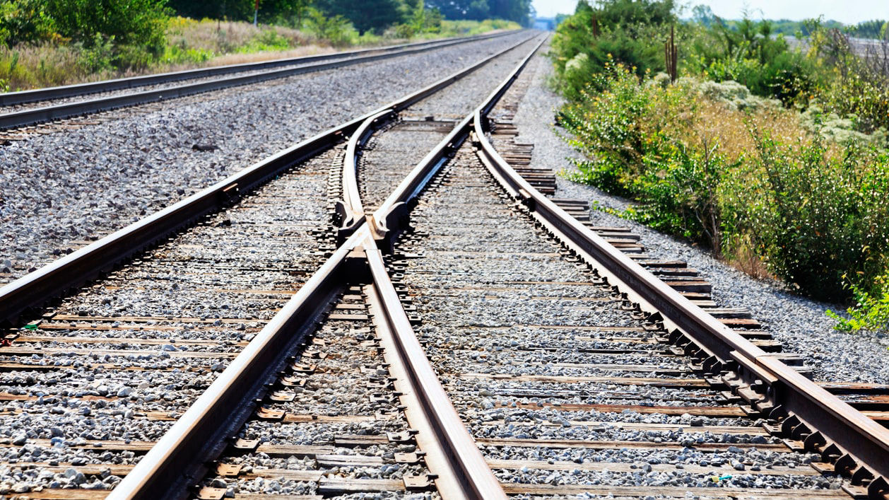 Two train tracks that are parallel to each other.