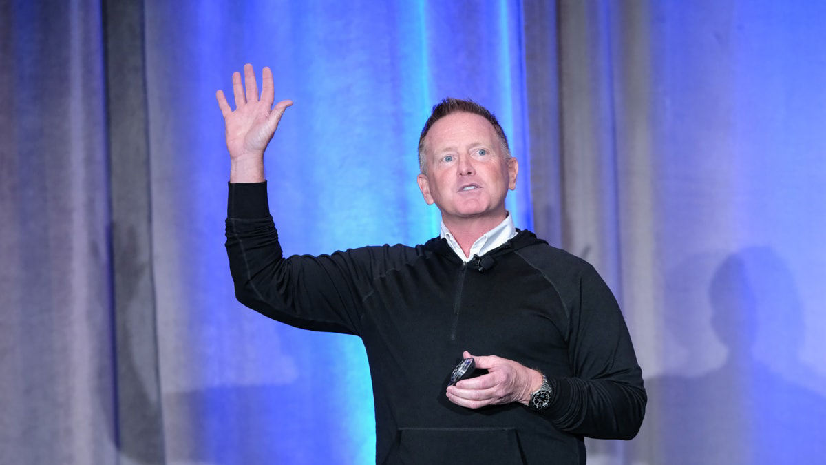 A man giving a speech at a conference.