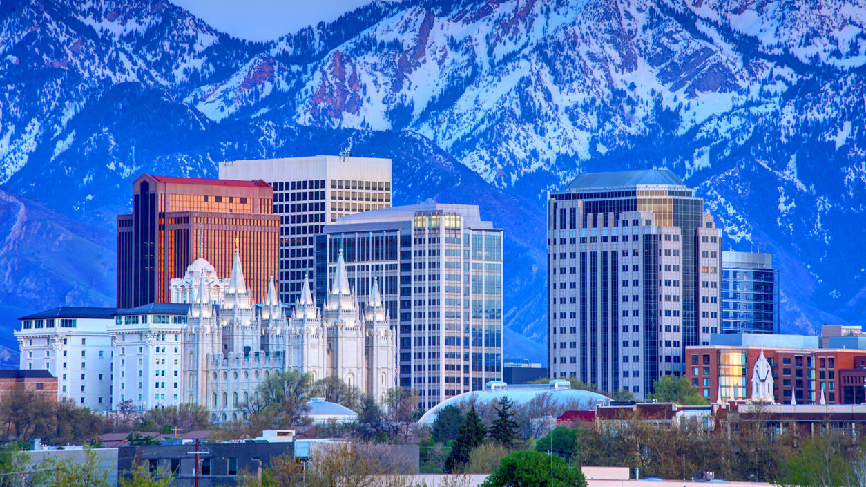 The salt lake city skyline with snowy mountains in the background.