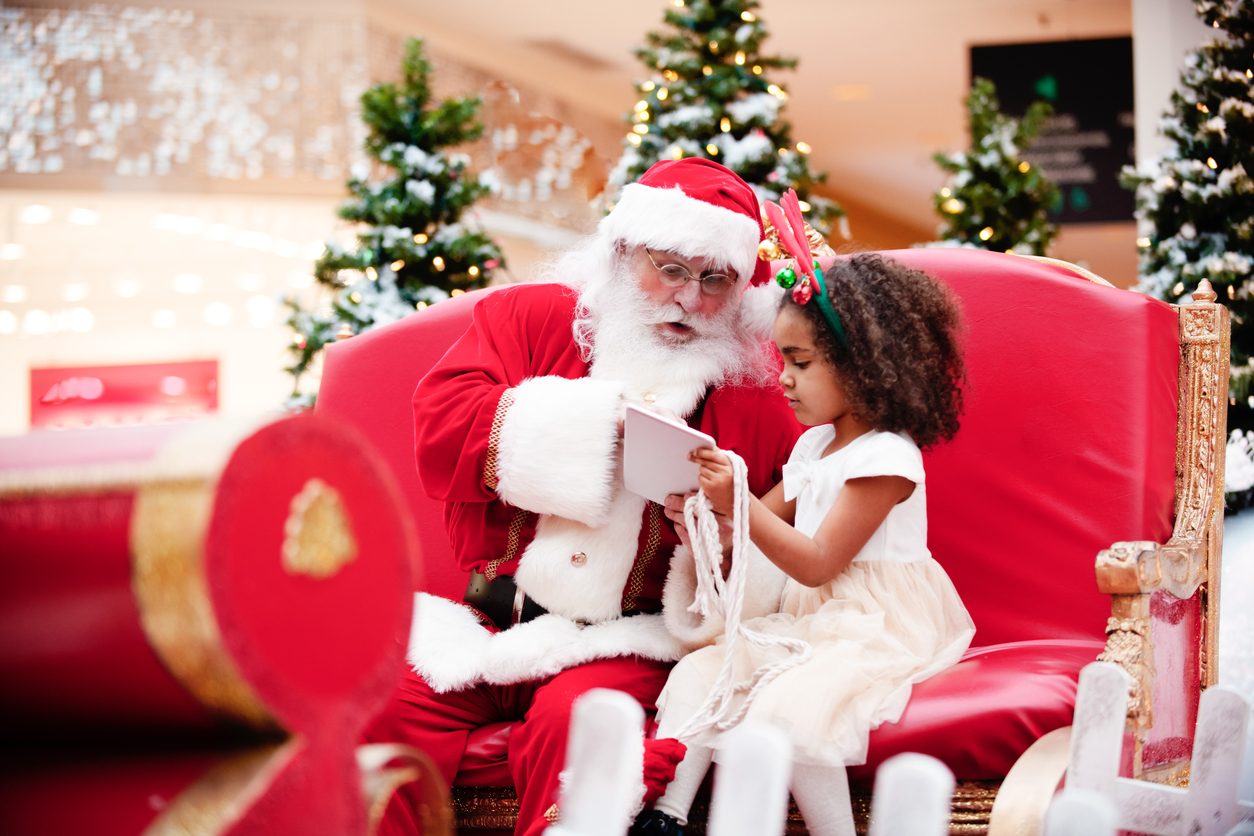 Santa and young girl in department store
