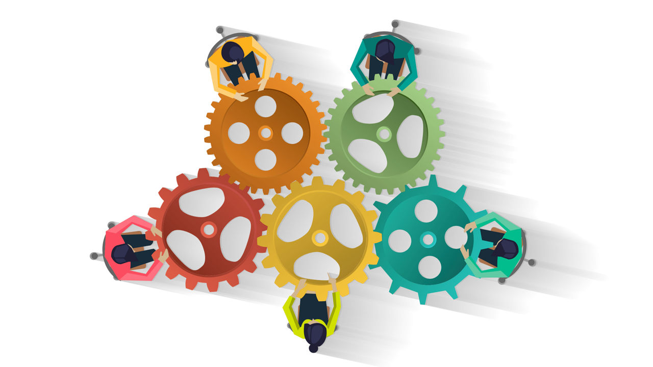 A group of people working together on a set of gears.