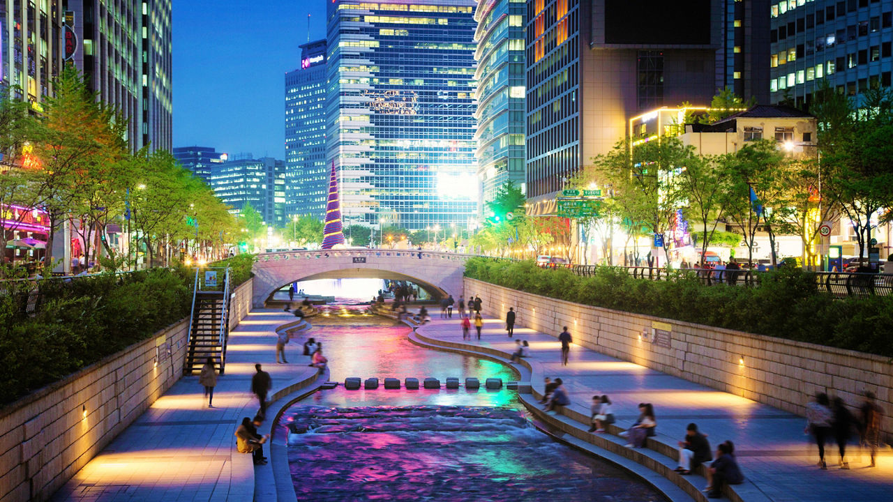 A canal in the middle of a city at night.