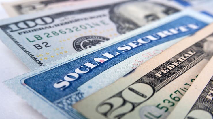 A stack of social security cards on a white background.