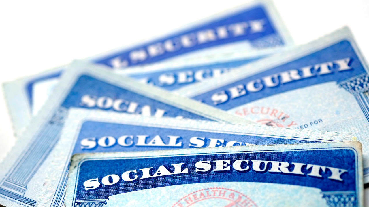 A stack of social security cards on a white background.