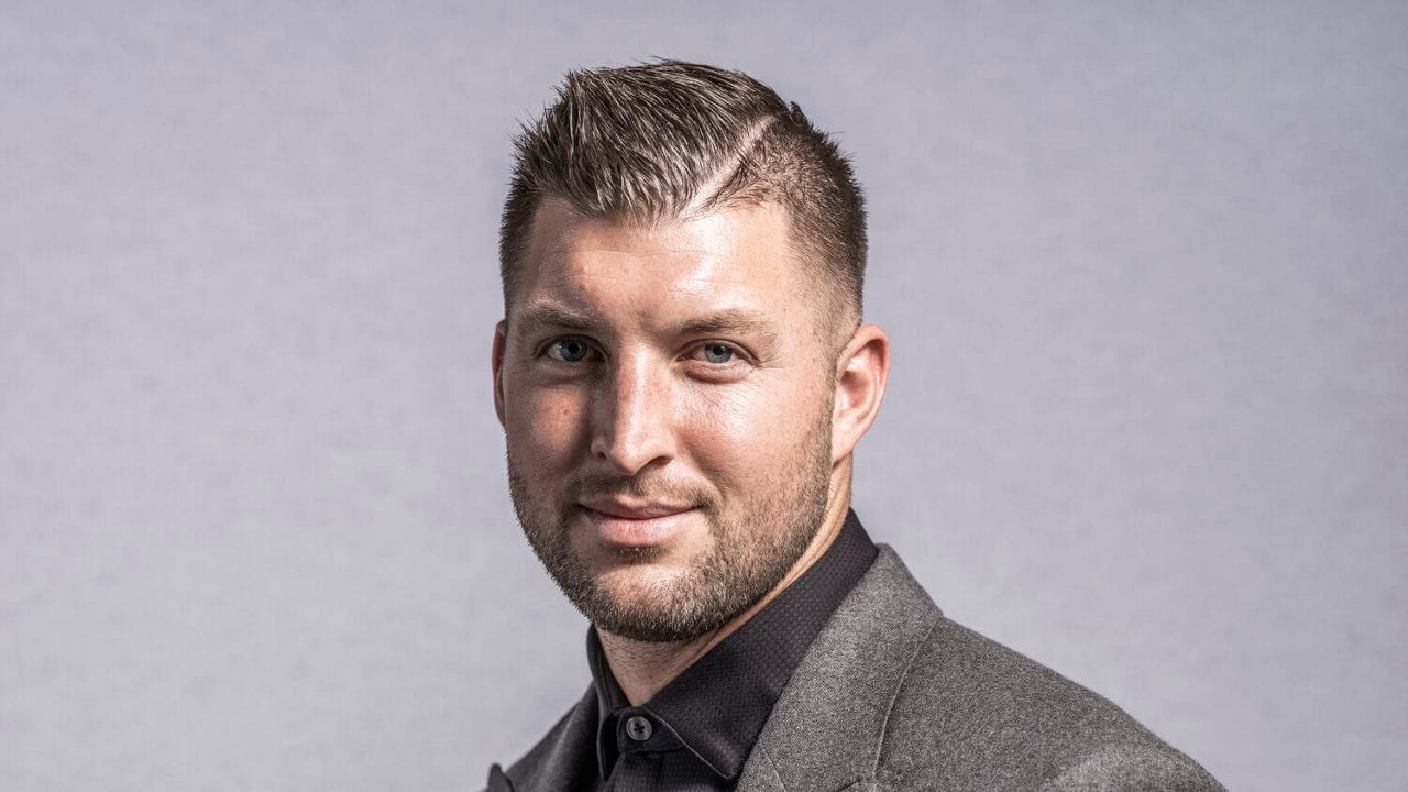 A man in a suit posing for a photo.