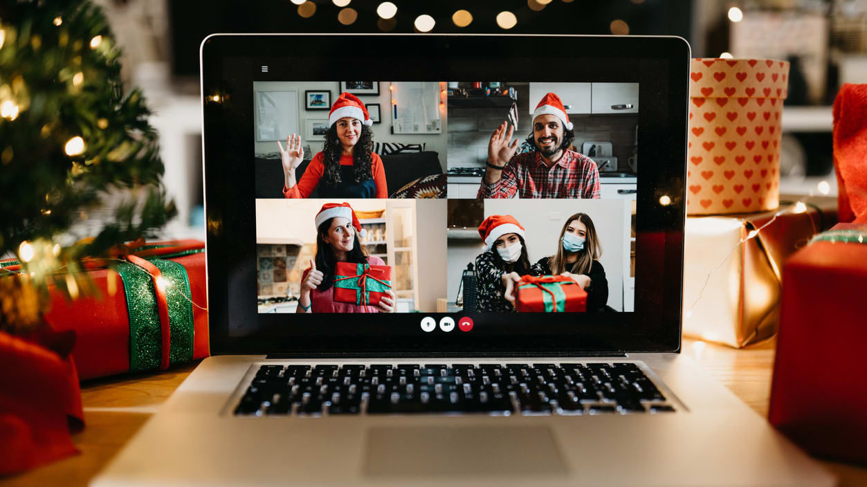 A laptop screen with a group of people on a christmas video call.