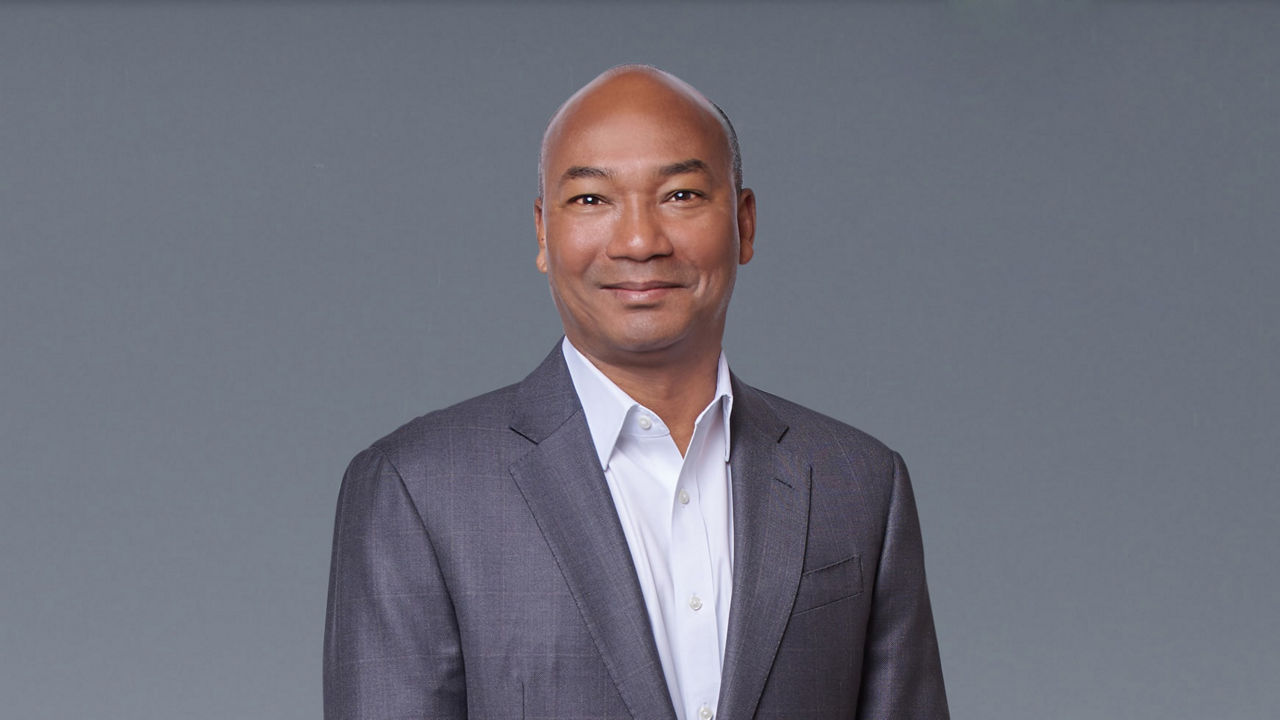 A man in a suit posing for a photo.