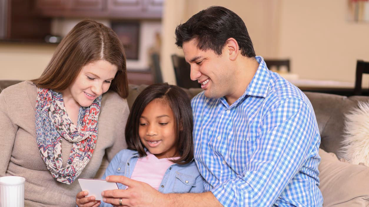 Parents enjoy time with adopted daughter. 