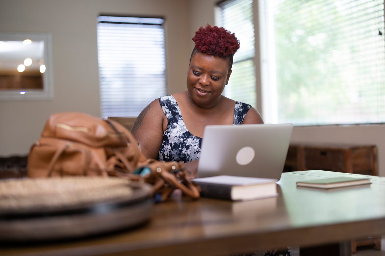 A woman uses her laptop to work on online learning.