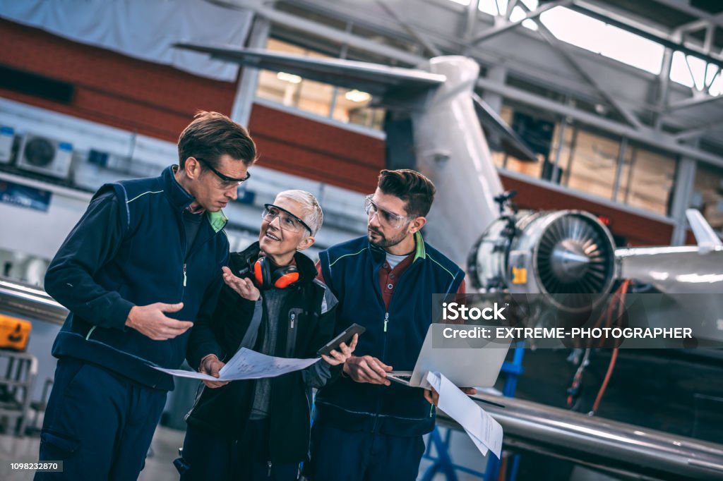 three aerospace engineers at worksite