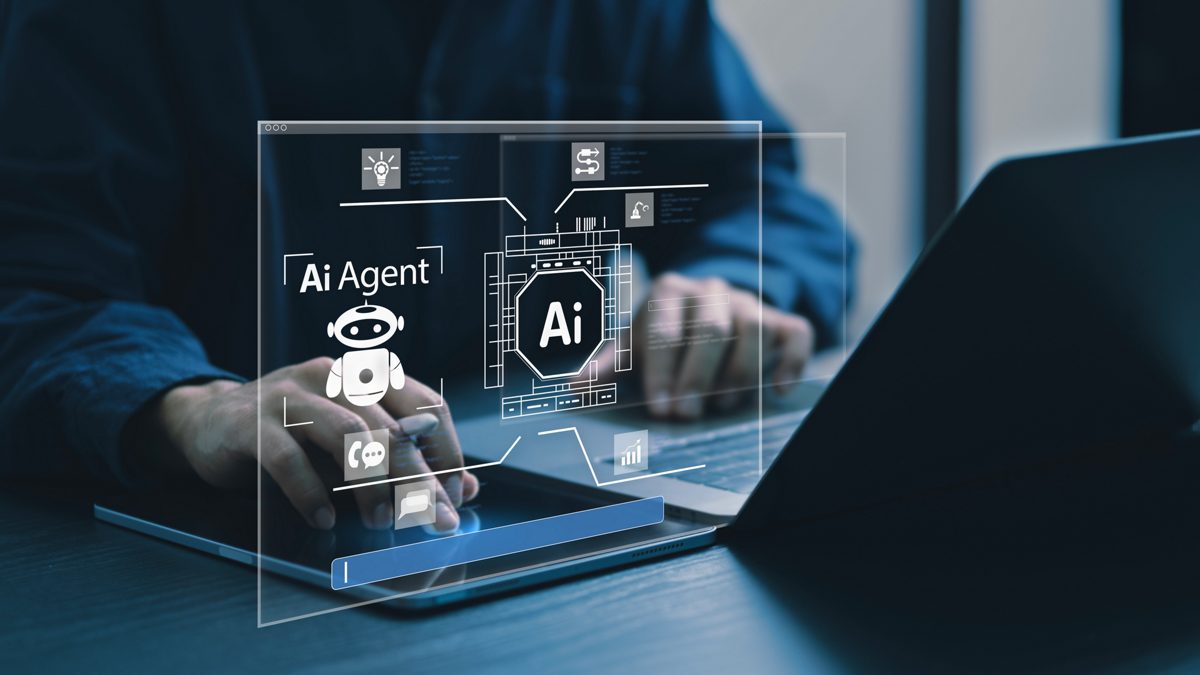 Hands on a laptop keyboard with futuristic AI overlay on top