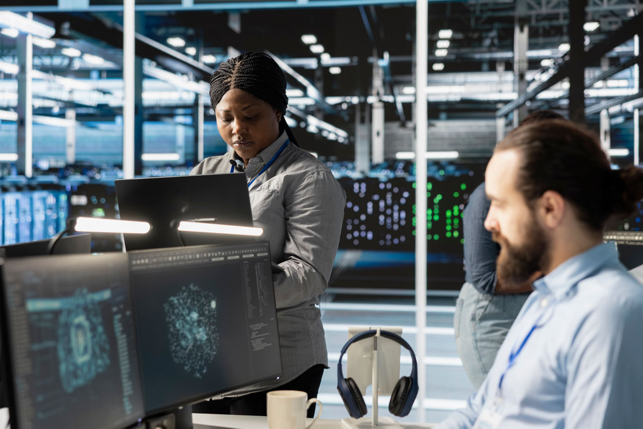 Engineers doing maintenance on blade servers supplying compute power for AI data processing and inference workloads. IT experts overseeing data center arrays managing training datasets