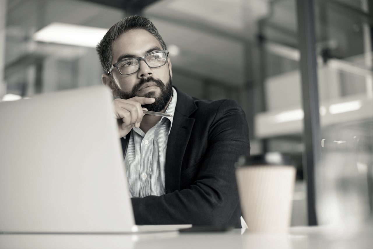 A professional sitting in front of a computer