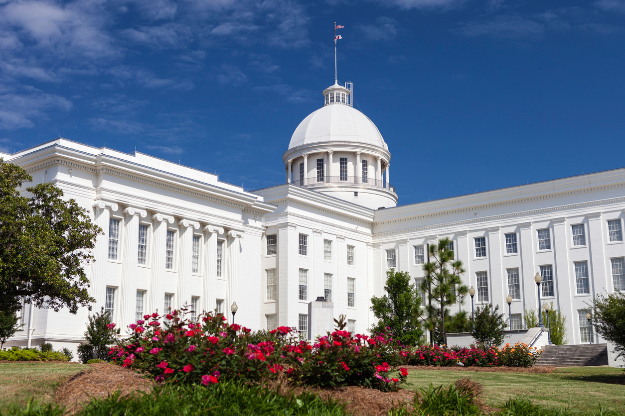 The Alabama State Capitol on a sunny day in Montgomery with roses blooming.