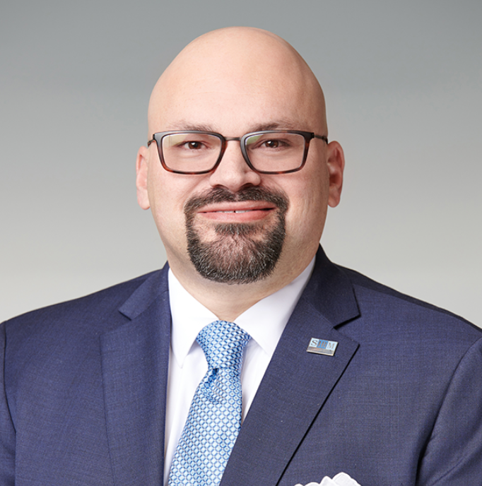Alex Alonso in a blue suit. 