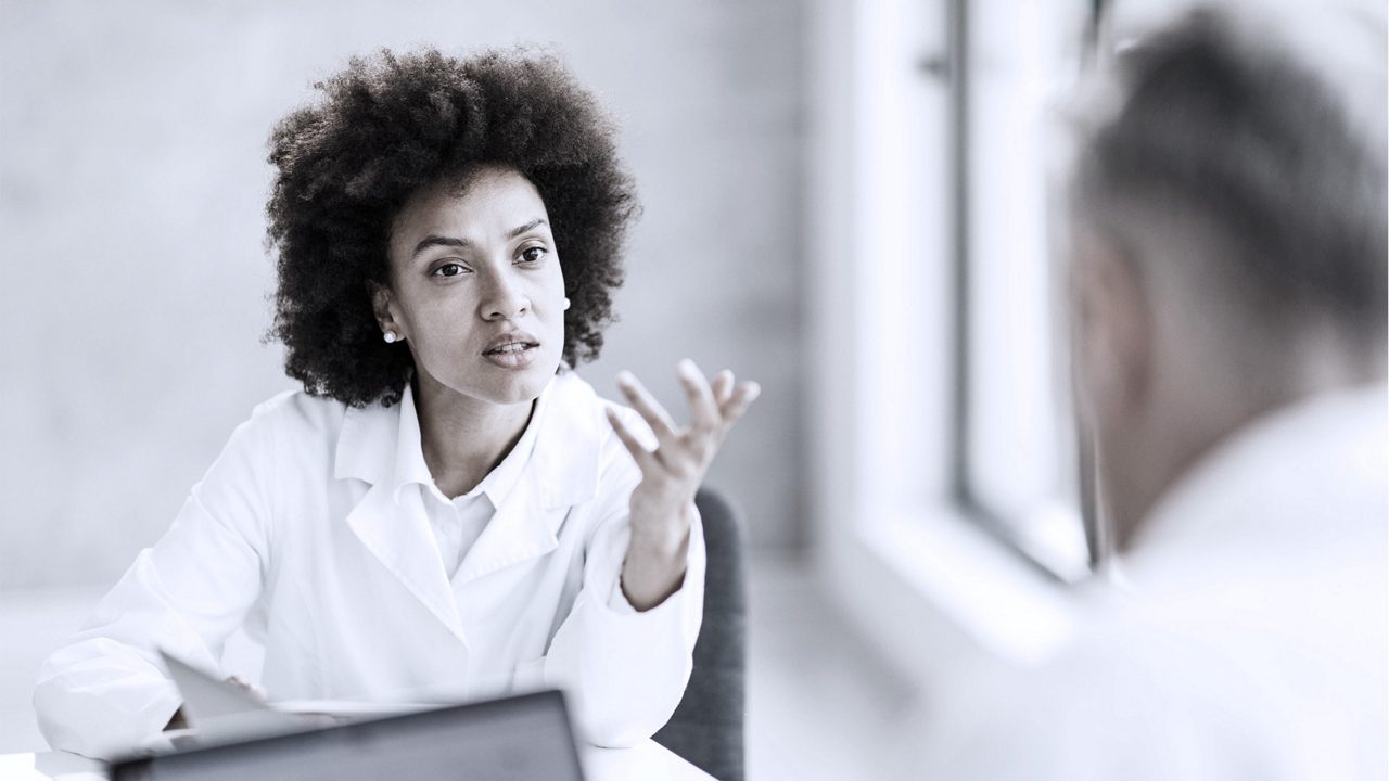 manager in office talking to employee