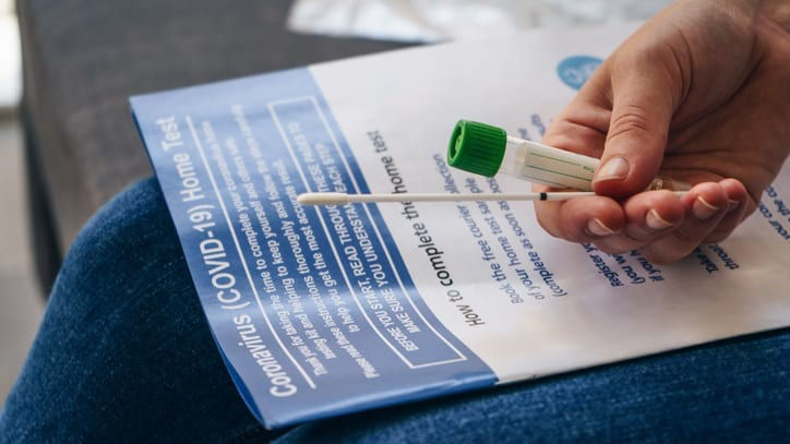 A person is using a toothbrush to clean a piece of paper.