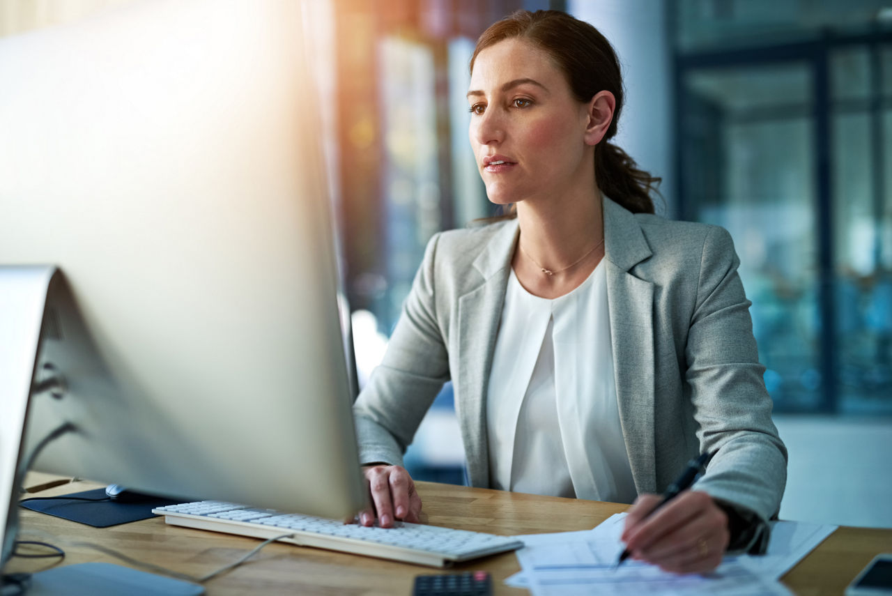 Shot of a businesswoman working behind her computer in the office.