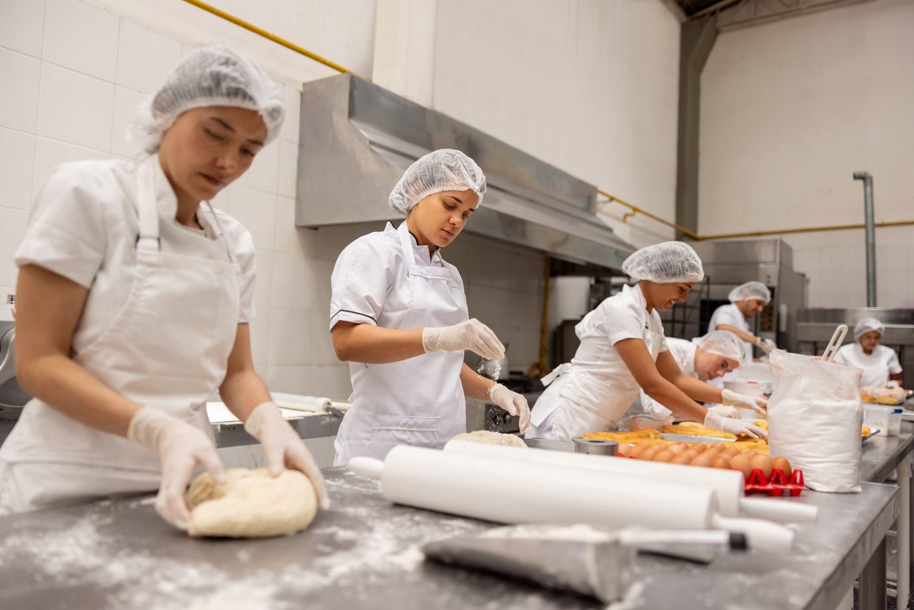 group of bakers rolling bread