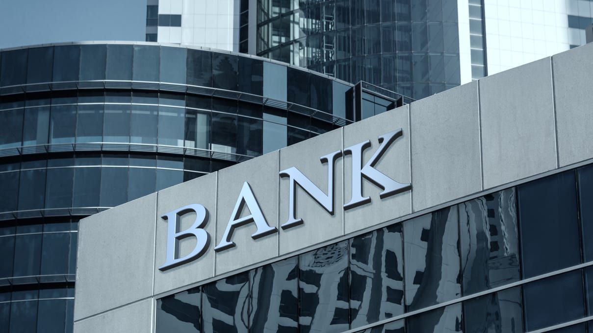 A bank sign on the side of a building.