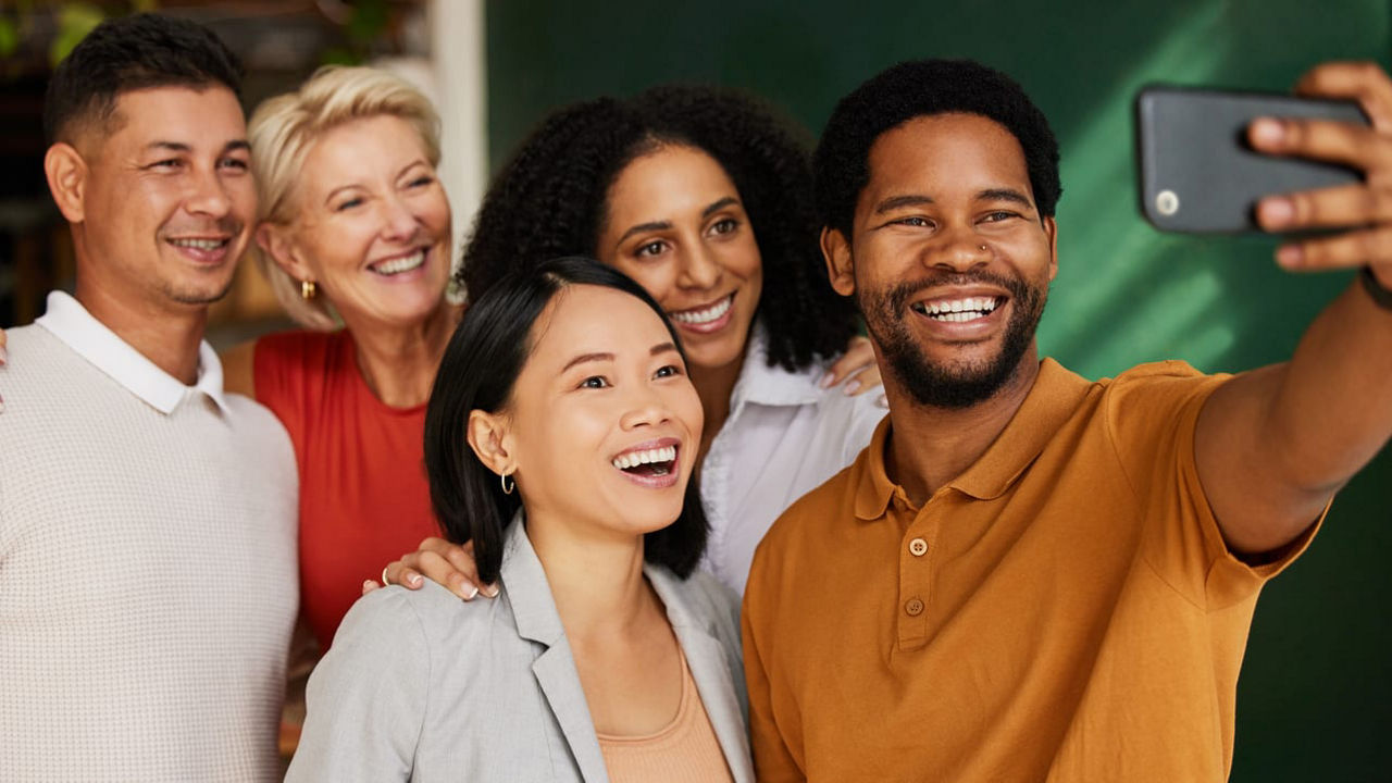 A group of people taking a selfie in a classroom.