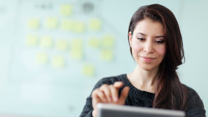 A woman using a tablet computer in an office.