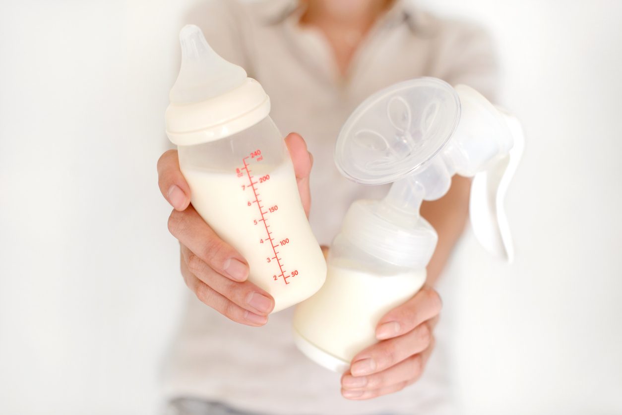 woman holding bottle and pump