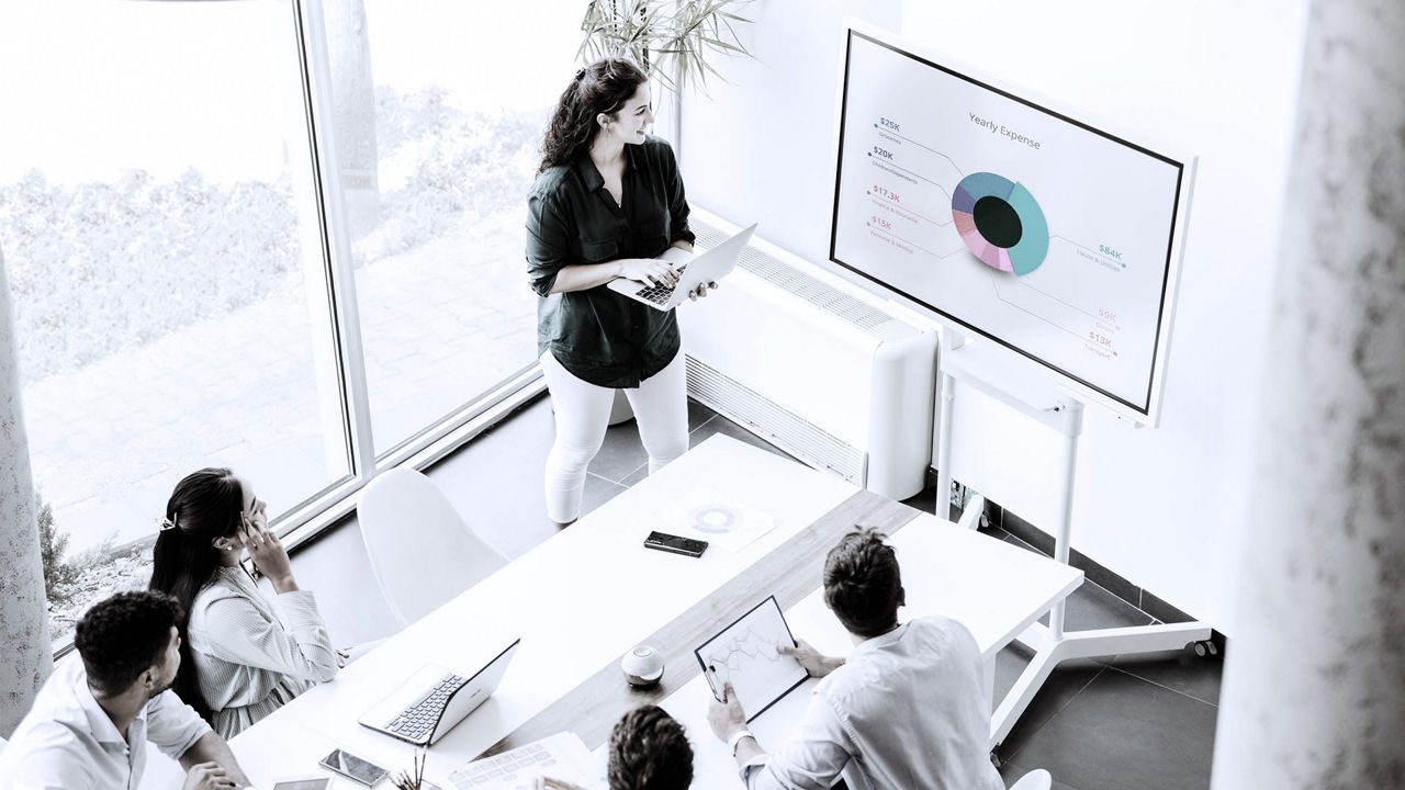A group of people sitting around a table in a conference room.