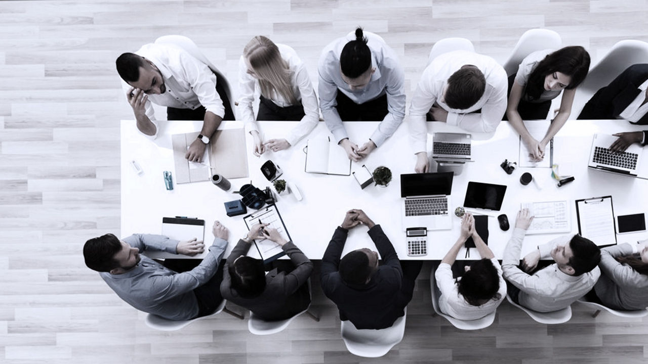 business people sitting around a boardroom table