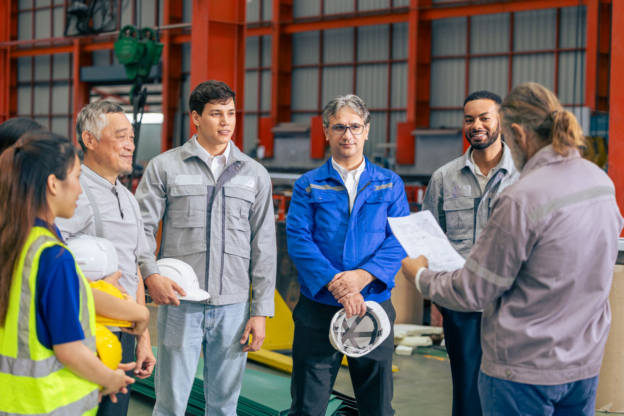 Senior supervisor industry team workers meeting, Professional working group leader reading work procedures agreement safety regulation documents to team member