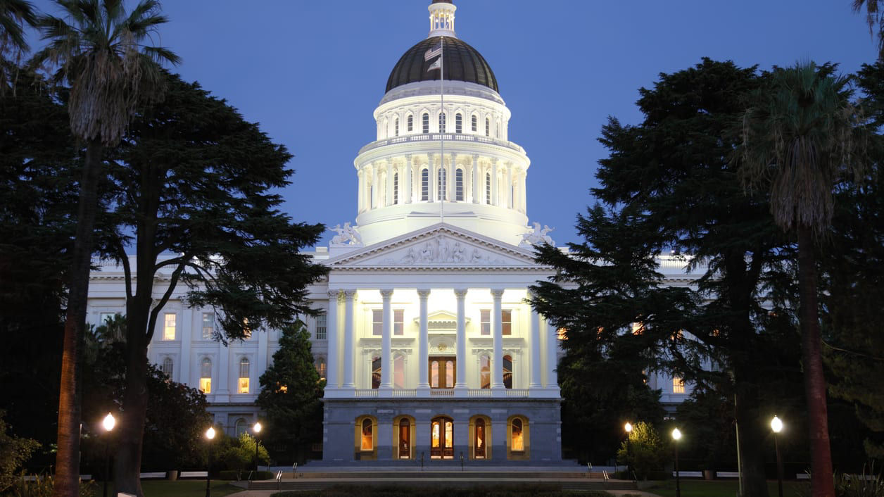 California state capitol building lit up at night.