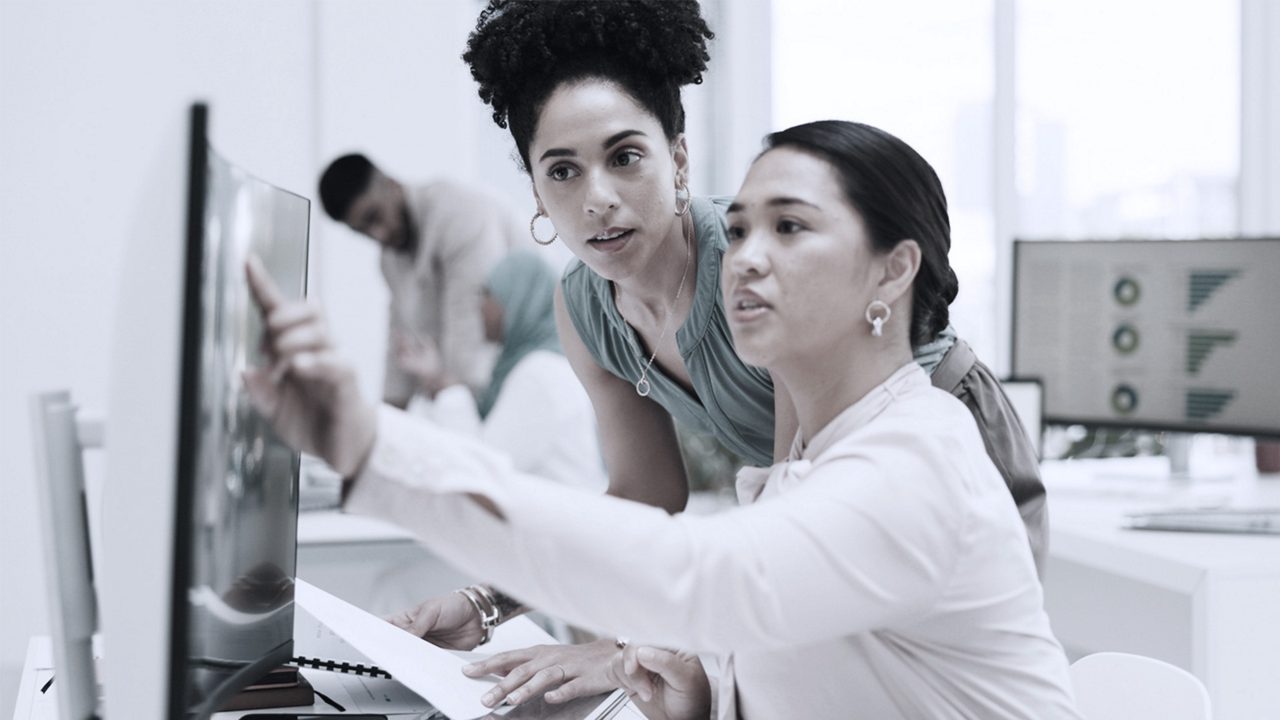 office worker pointing at computer