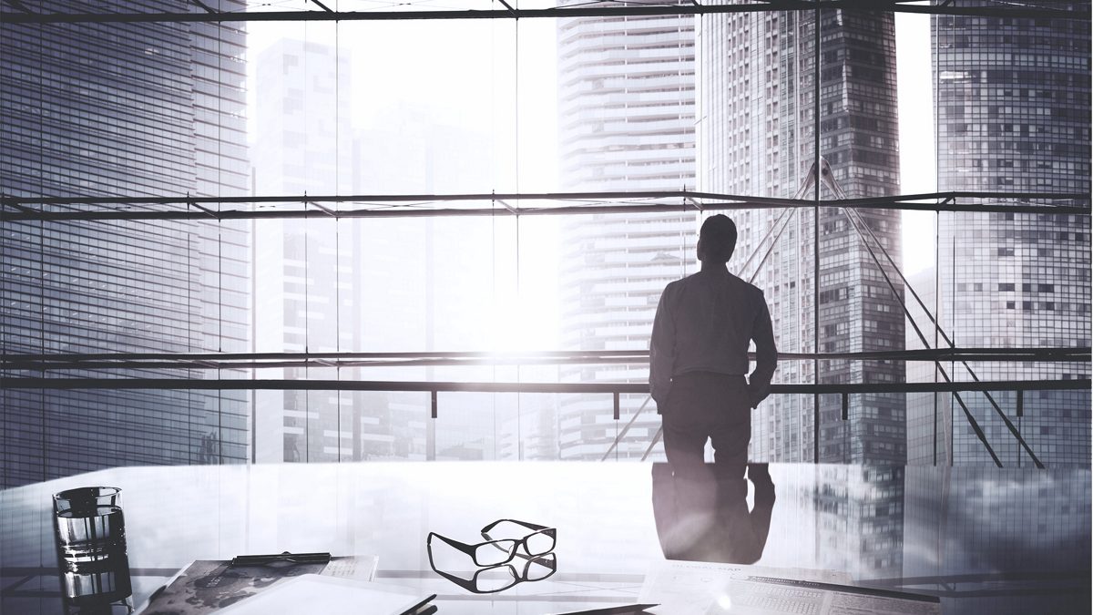executive looking out office window