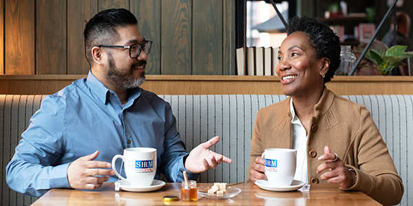 Civil conversation between two employees over tea.