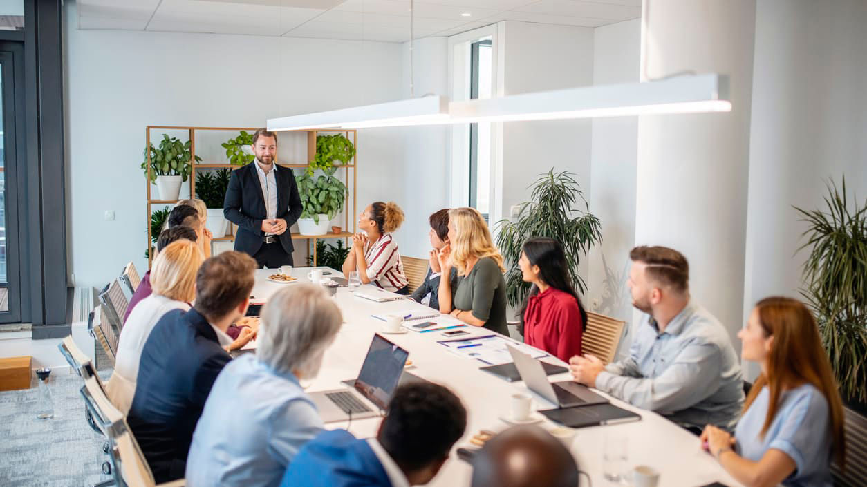 A group of business people sitting around a conference table.