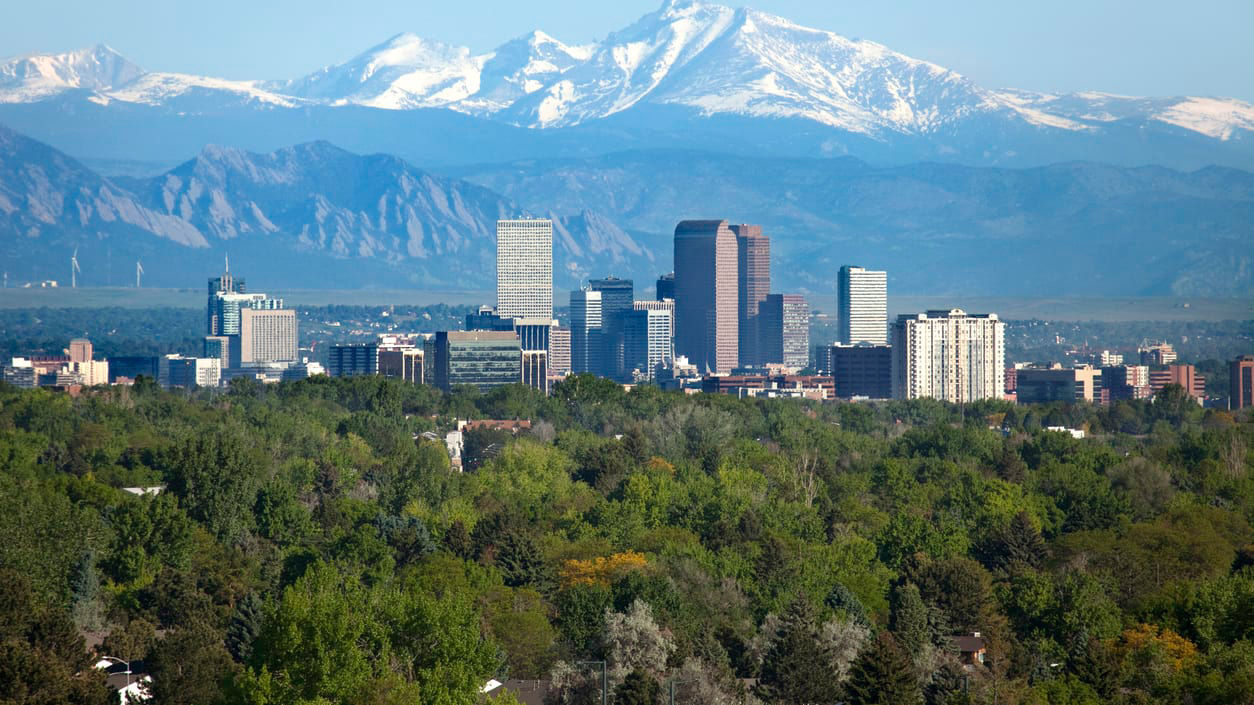 Downtown Denver with the Rocky Mountains in the background.